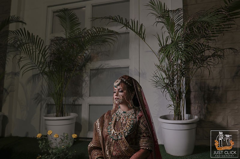 Bride posing outdoors in dark lighting