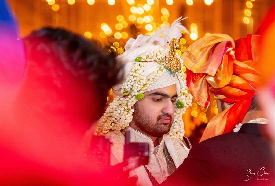 Close-up of groom wearing a traditional floral sehra veil