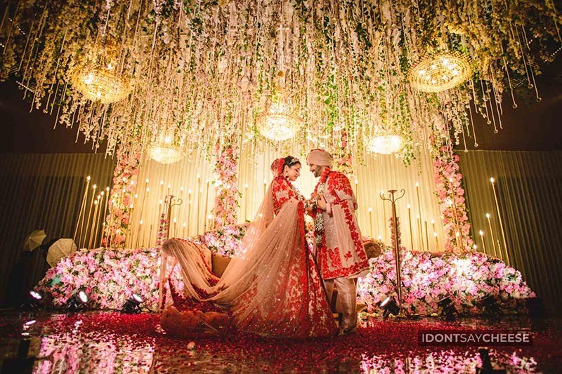 Bride and groom on stage with confetti falling around them
