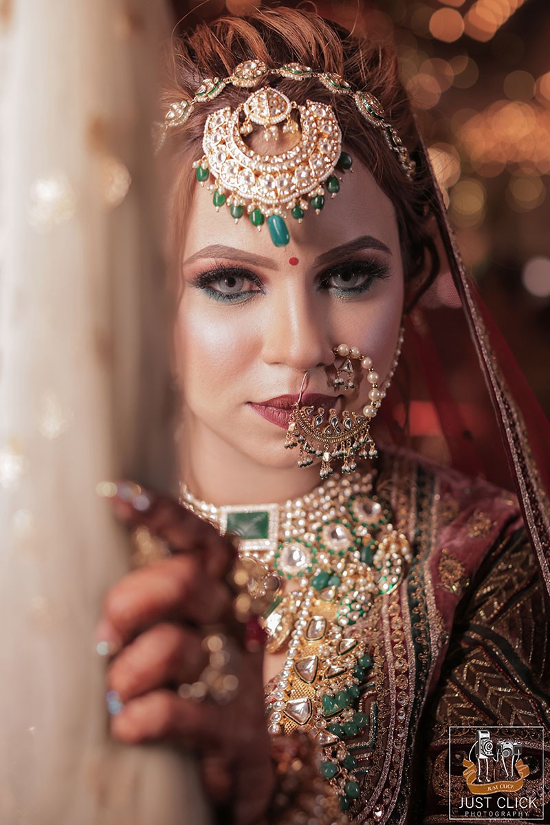 Close-up portrait of bride wearing heavy traditional jewellery