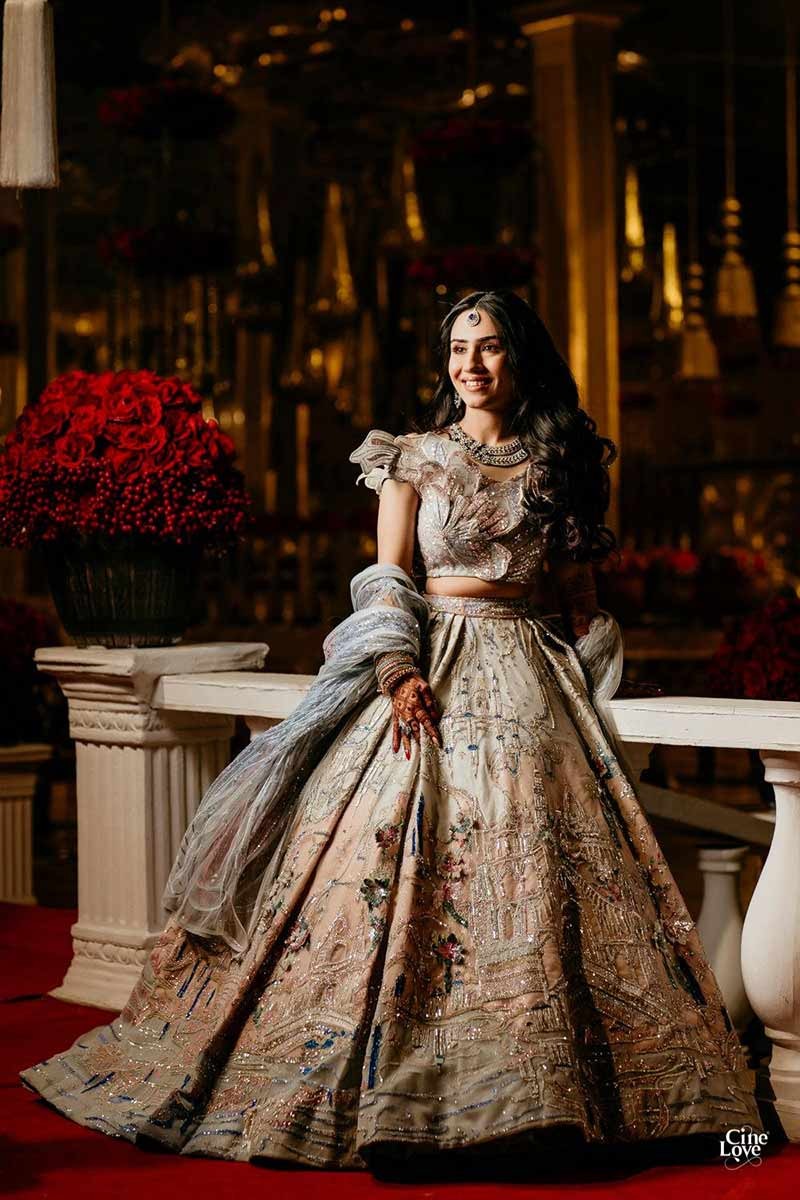 Bride showing the full length of her gold embellished gown