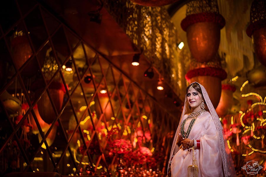 Warmly lit ceremony moment with candlelight glow at Prakriti and Sahil's wedding