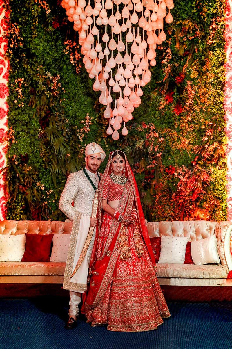 Priyansh and Priyanka in traditional attire at their wedding