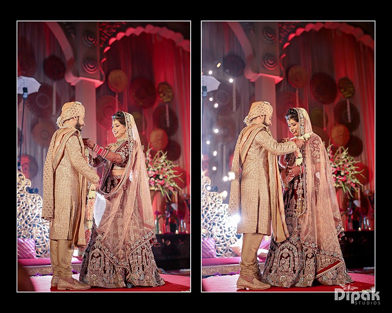 Portrait of Deepak and Anjali amid warm wedding decor