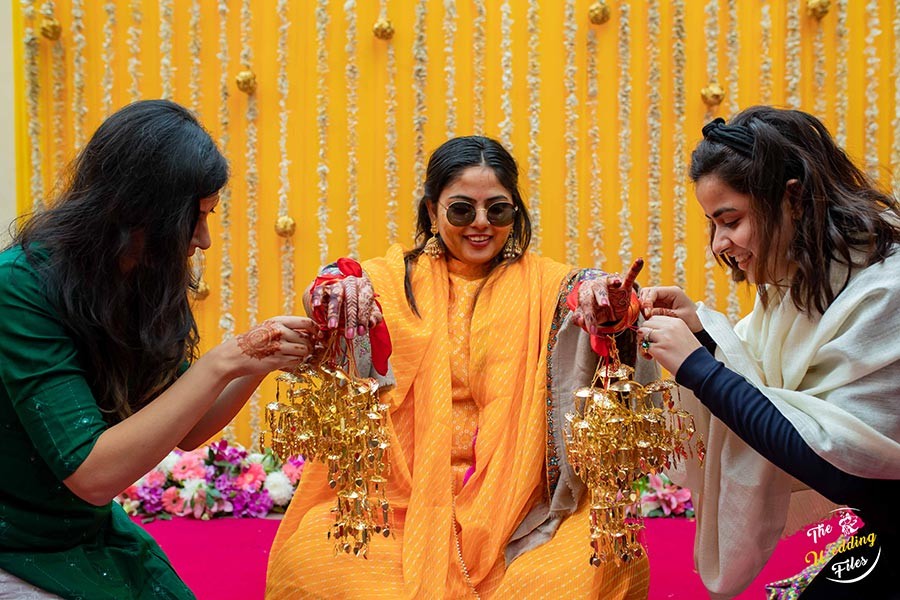 Bride Sanya in vivid traditional attire during a ceremonial ritual at her wedding to Anish