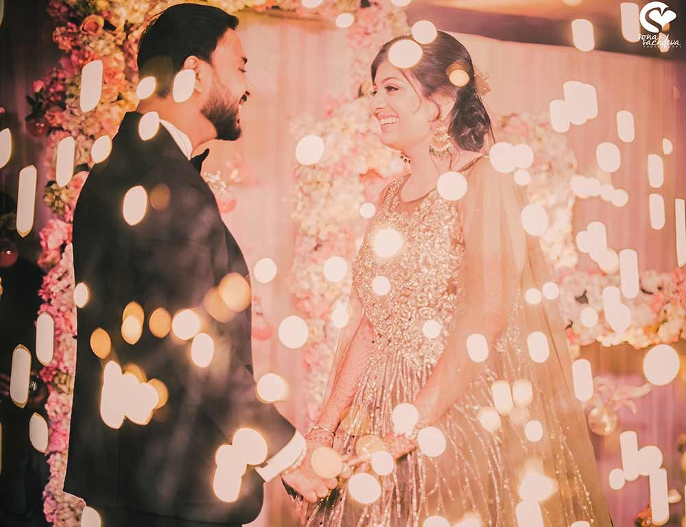 Romantic portrait of Deepanshu and Sonali surrounded by soft floral decor at their wedding