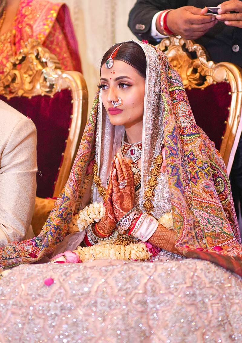Close-up portrait of bride against floral decor