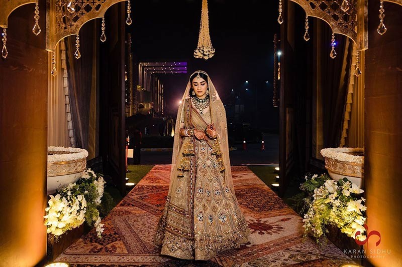 Bride and groom posing with a family member