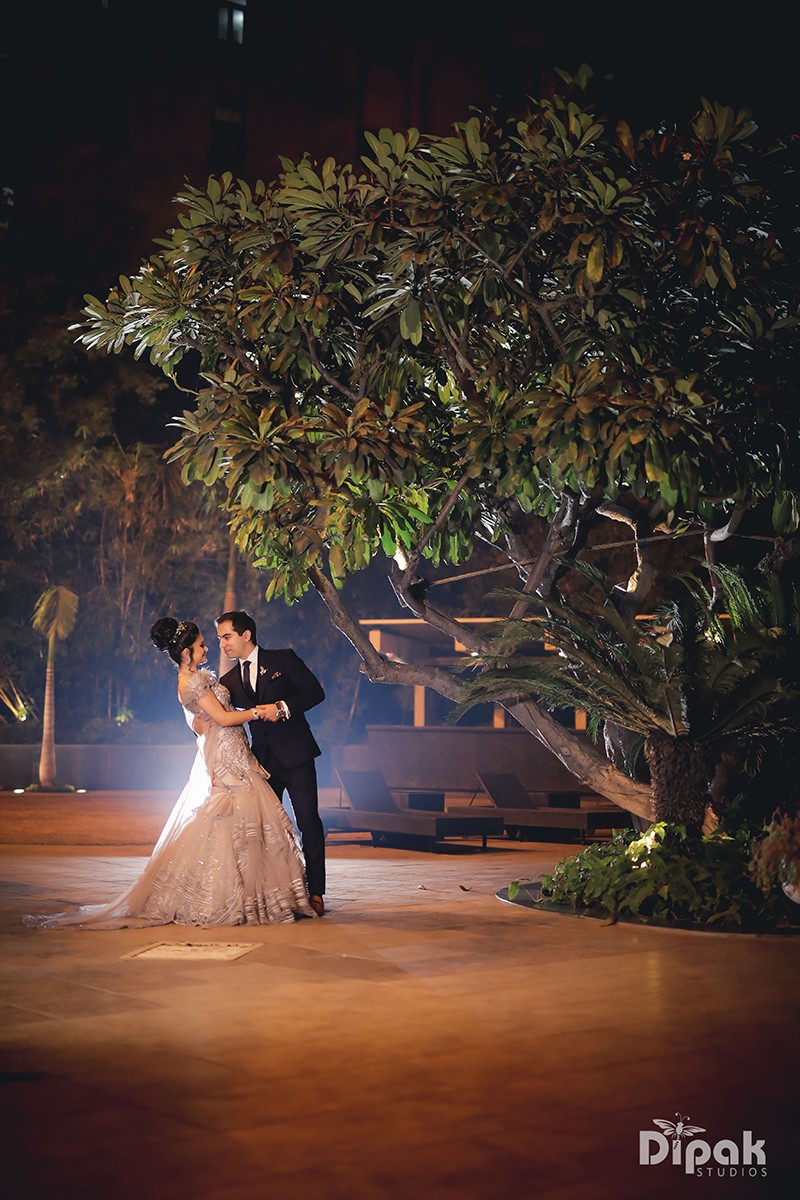 Ria and Manyu together under a decorated night setting with ambient lighting