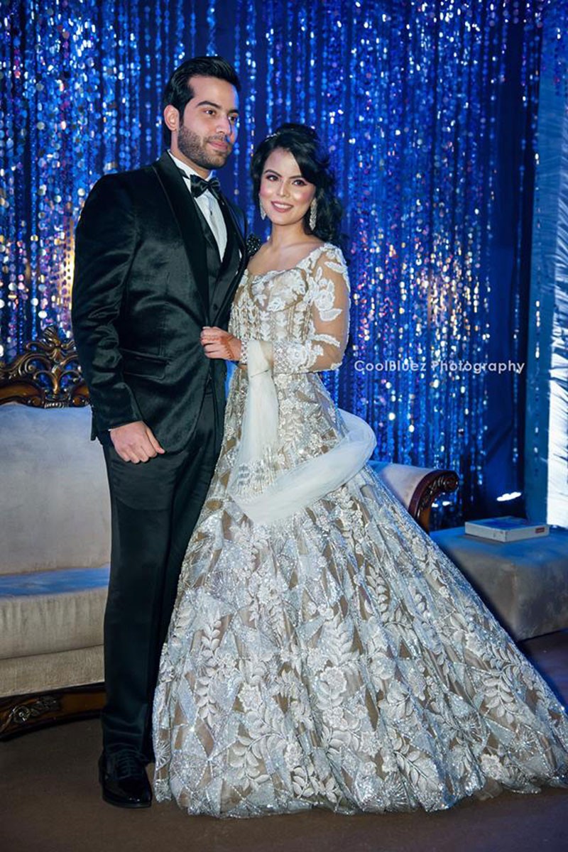 Bride Neha in an elaborate gown at her wedding reception