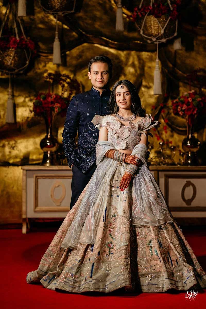 Bride showing the full length of her gold embellished gown