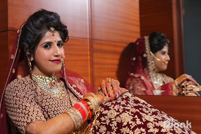 Bride Garima in a red outfit at her wedding