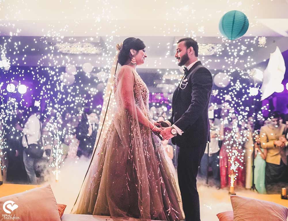 Deepanshu and Sonali walking together amid decorated florals during their wedding ceremony
