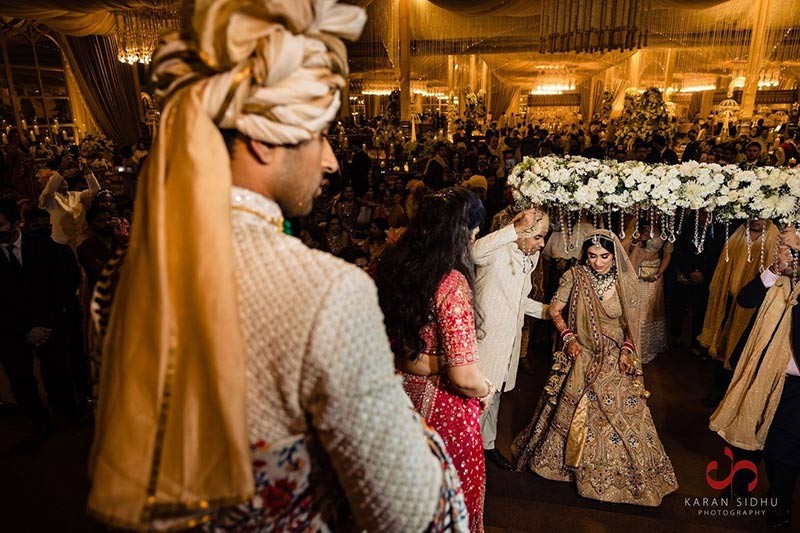 Groom standing solo in dark formal wedding attire