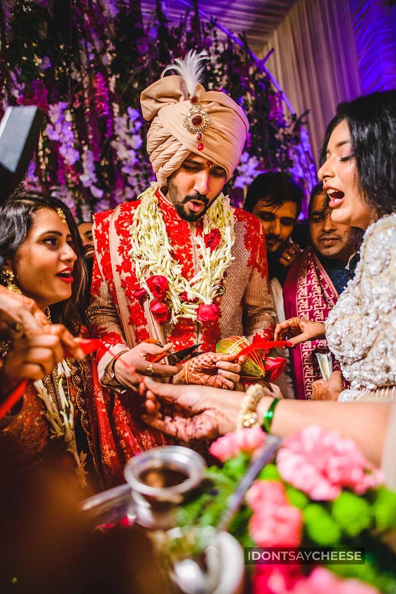 Close-up of bride and groom together under colourful decor