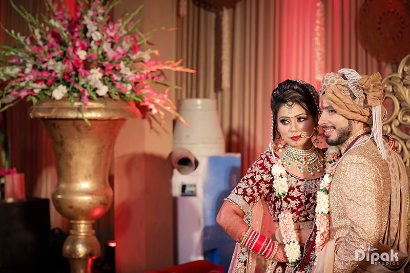 Deepak and Anjali at their wedding ceremony amid warm decor