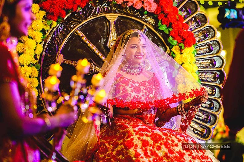 Bride and groom standing together at a floral mandap