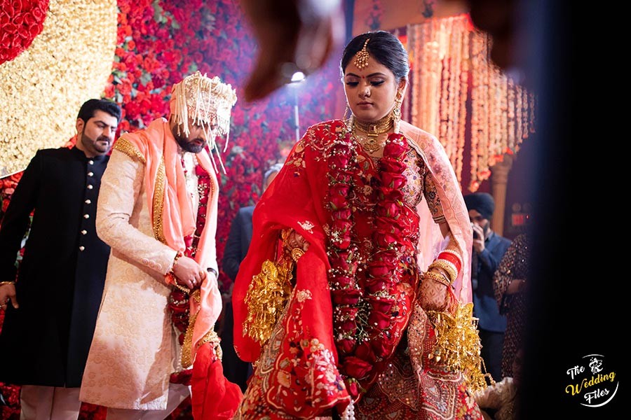 Sanya and Anish in vibrant traditional attire during a wedding ritual