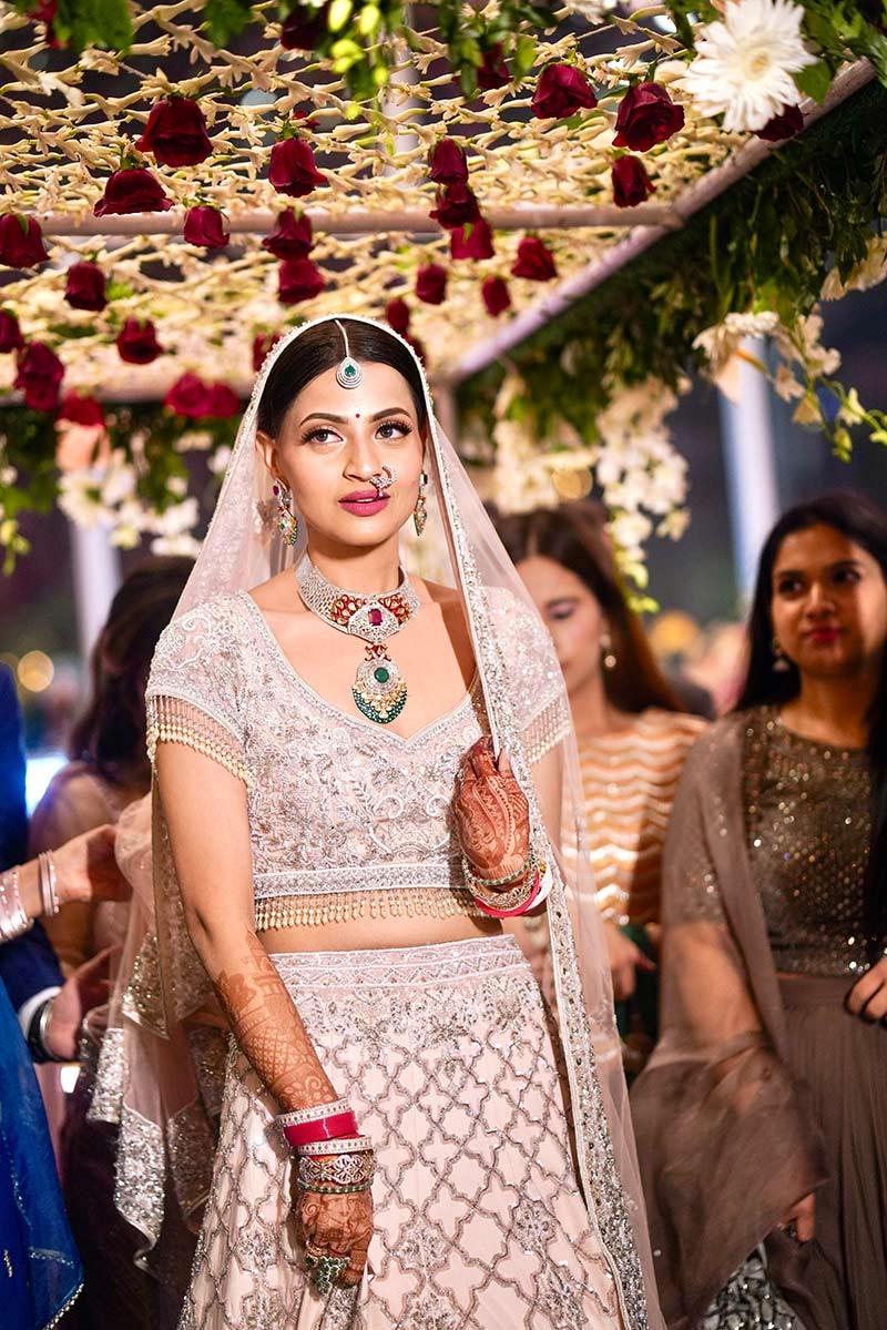Bride showing the full length of her red bridal outfit