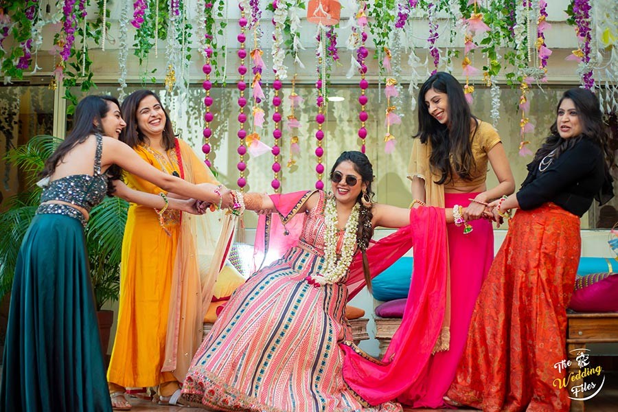 Bridal party in colorful outfits gathered together at Sanya and Anish's wedding
