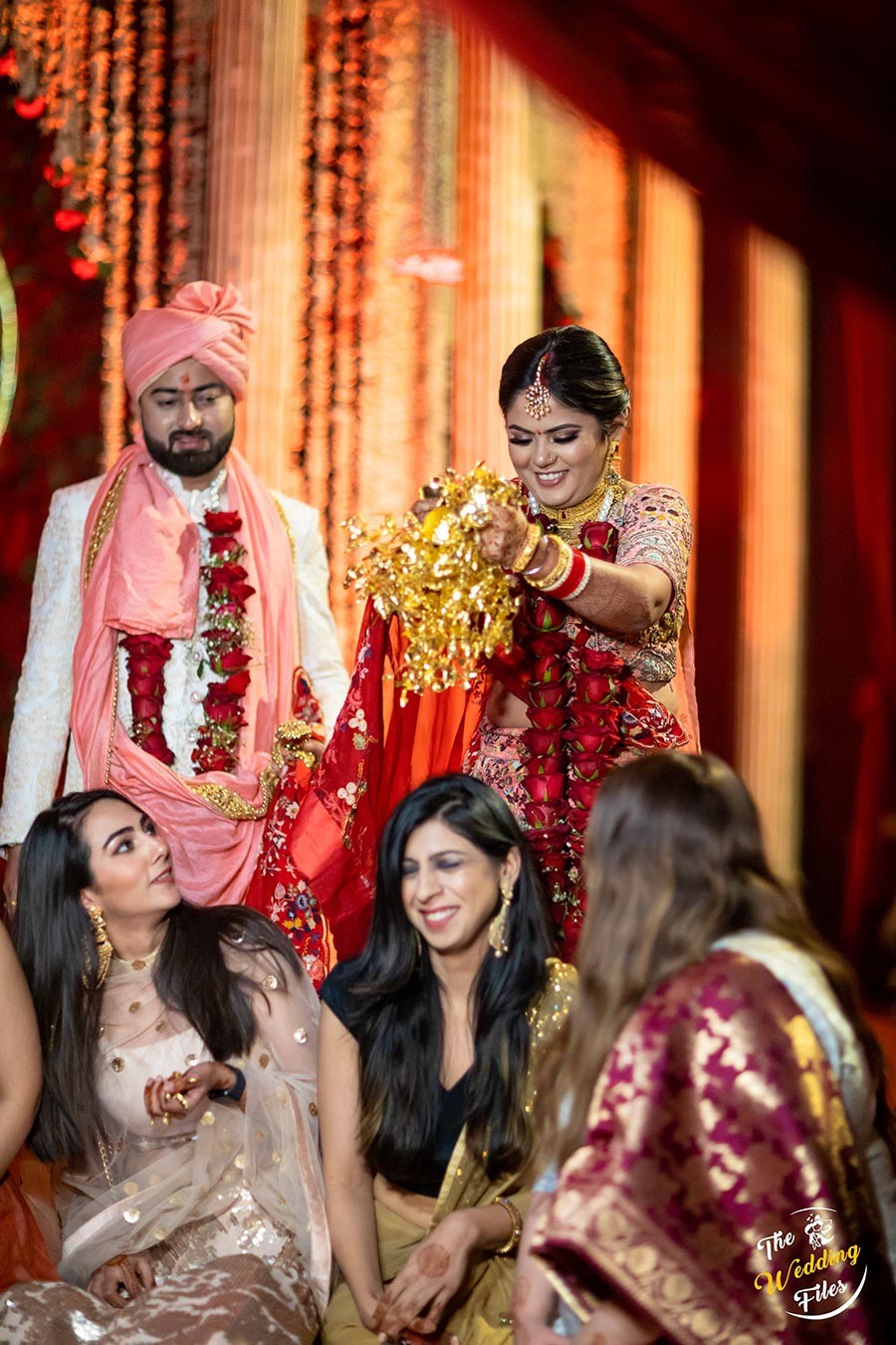 Sanya and Anish in traditional attire during a wedding ritual