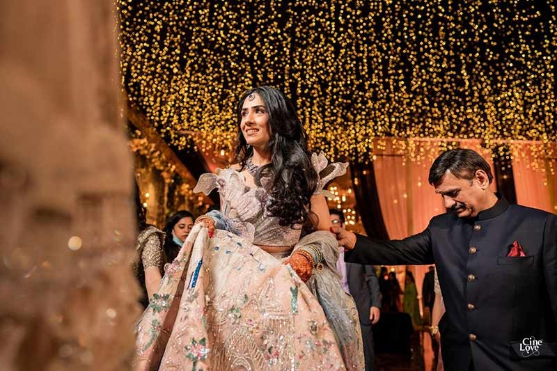 Bride and groom posing closely together with confetti falling