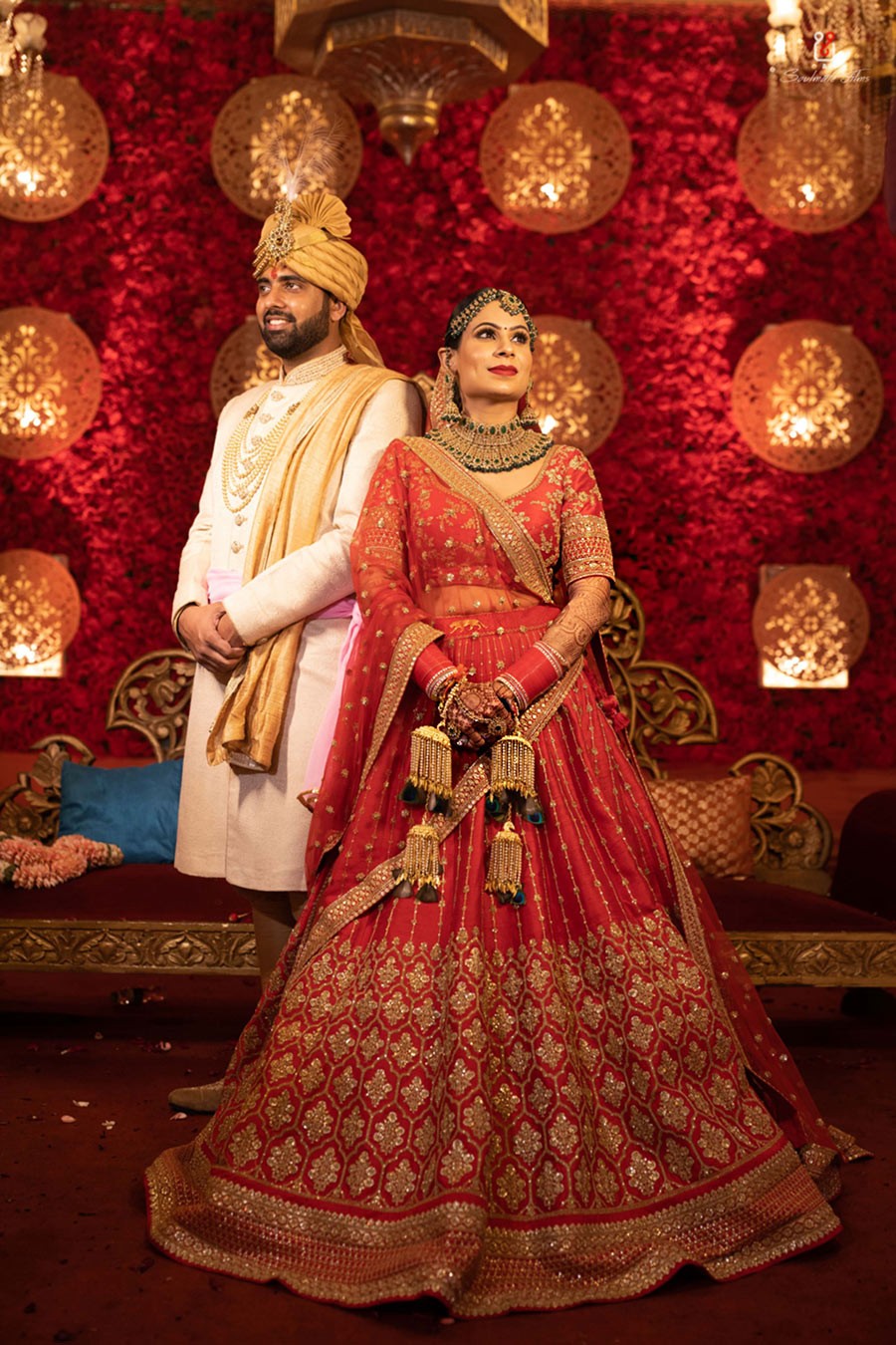 Ayushi and Shashwat in red wedding attire during their ceremony