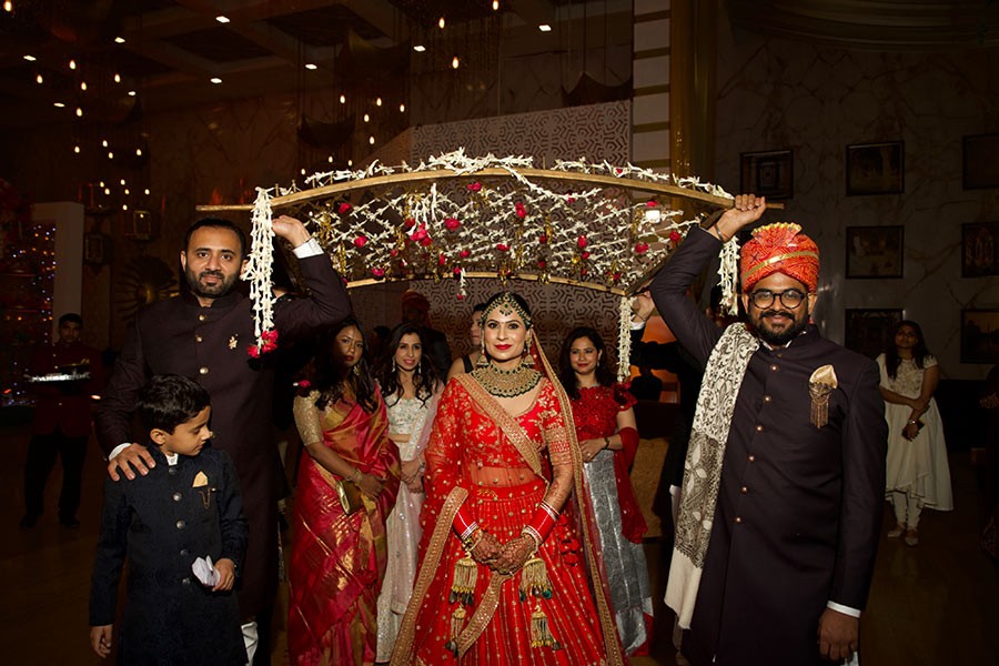Ayushi and Shashwat celebrating amid sparklers and confetti at their wedding