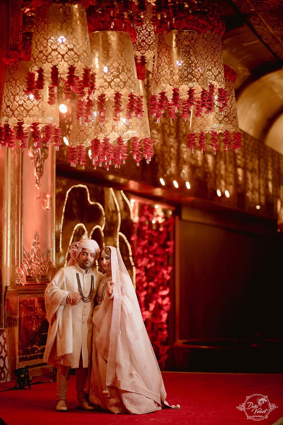Bride Prakriti in a richly detailed red bridal outfit during her wedding to Sahil