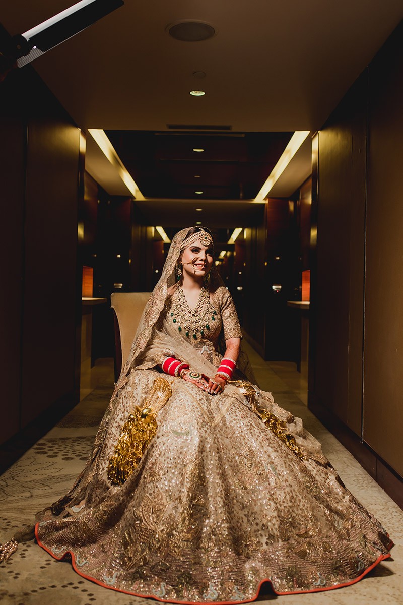 Bride Neha in ornate bridal attire amid wedding decor