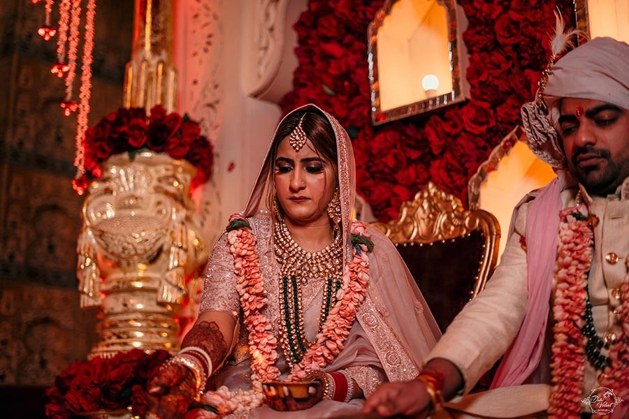 Prakriti and Sahil seated together during a wedding ceremony in ornate attire