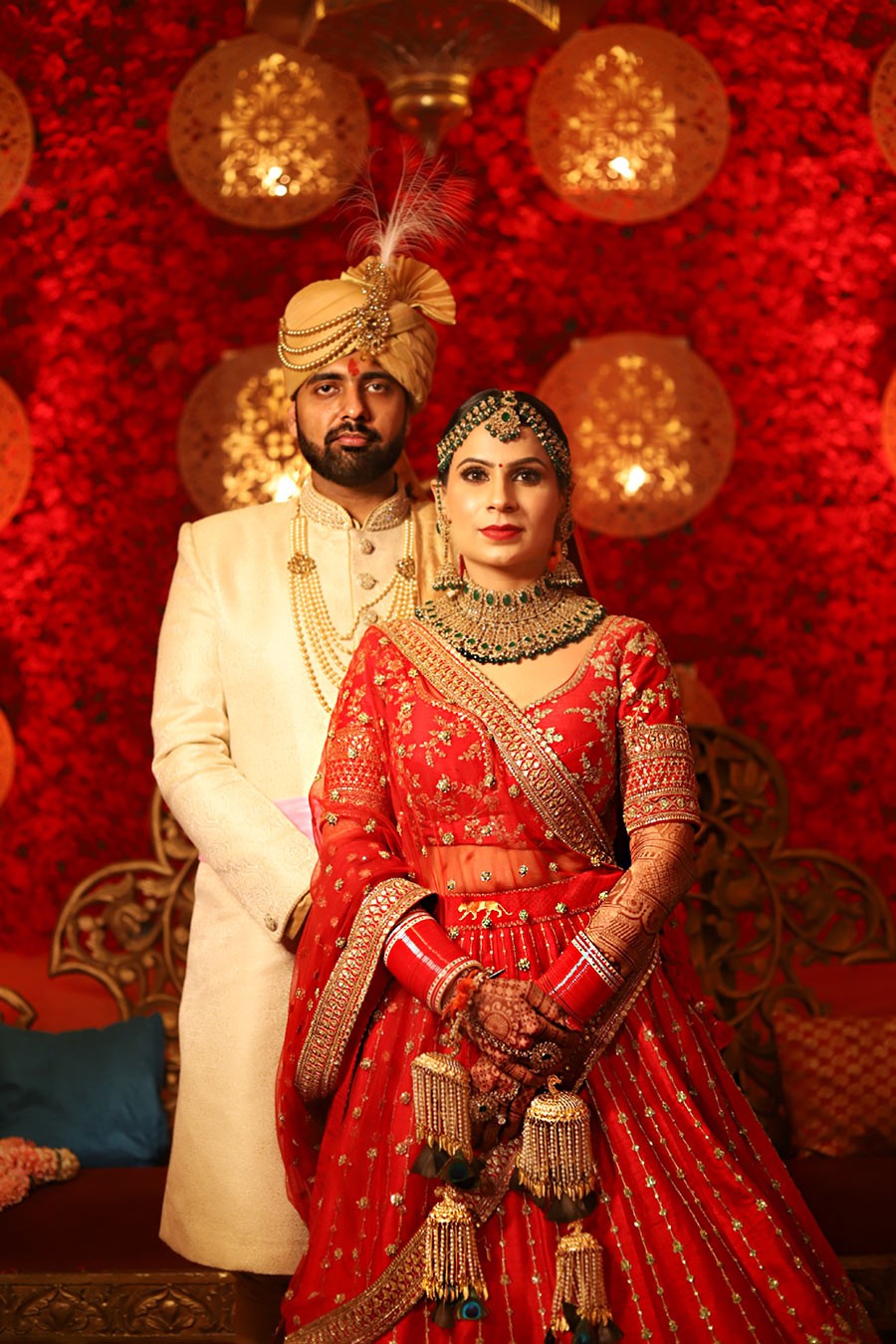 Close-up of Ayushi and Shashwat in red traditional attire at their wedding