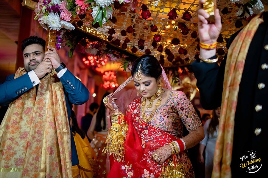 Sanya and Anish surrounded by family in festive attire at their wedding celebration