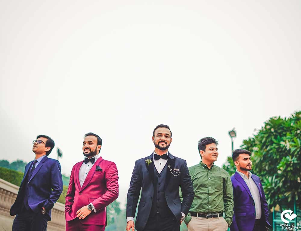 Deepanshu and Sonali with family members in coordinated festive attire at their wedding