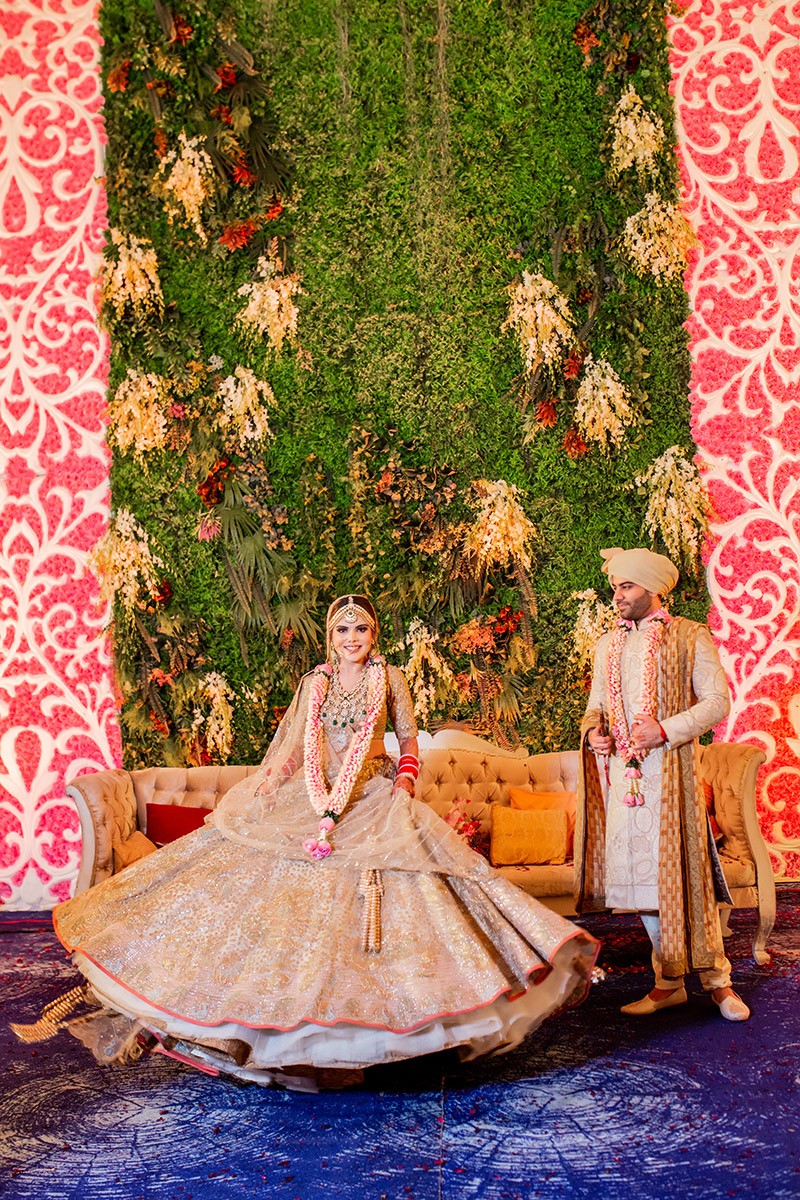 Neha and Pawan at their floral wedding mandap