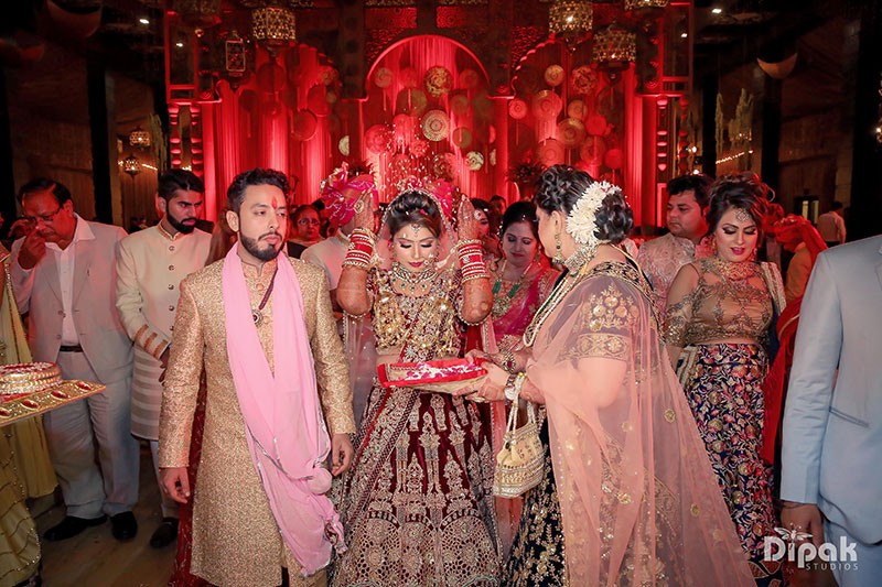 Deepak and Anjali with guests amid festive lighting at their FNP Venues real wedding