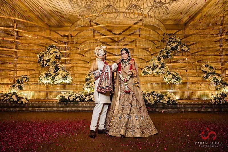 Bride and groom standing together in a warmly lit venue