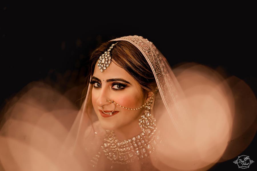 Portrait of bride Prakriti in elegant bridal jewelry during her wedding to Sahil