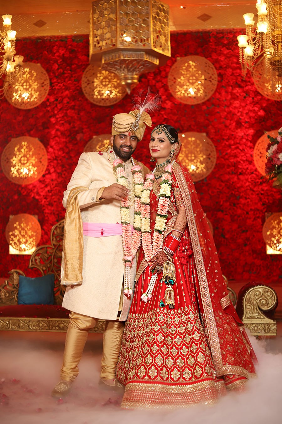 Ayushi and Shashwat posing together during their wedding celebration