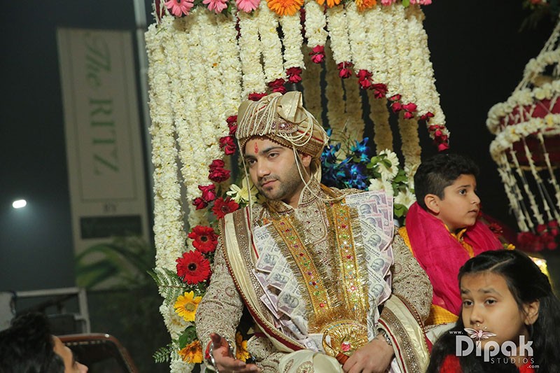 Rachit and Garima in red and gold traditional attire at their FNP Venues real wedding