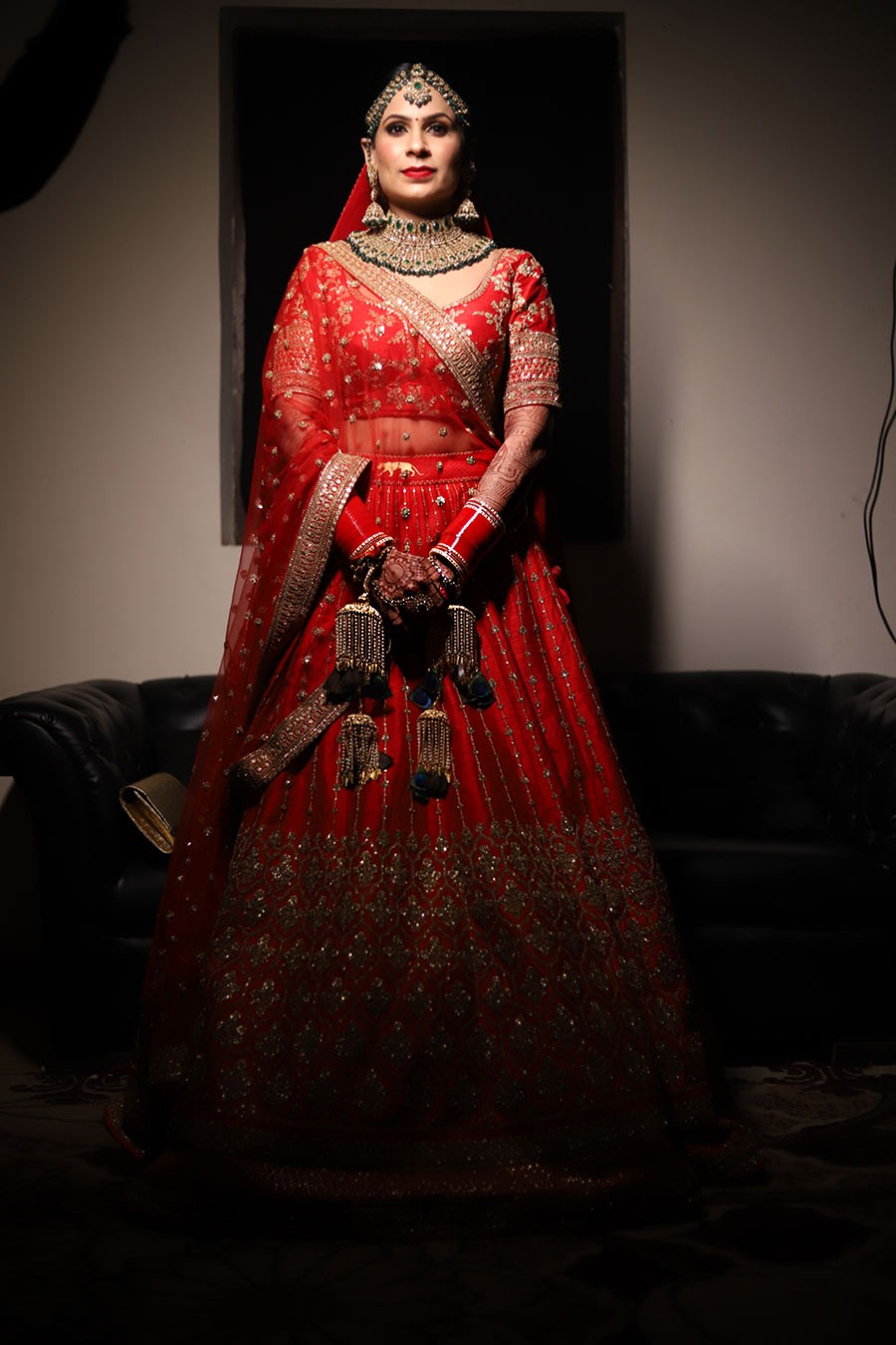 Ayushi and Shashwat in red traditional attire during their wedding ceremony