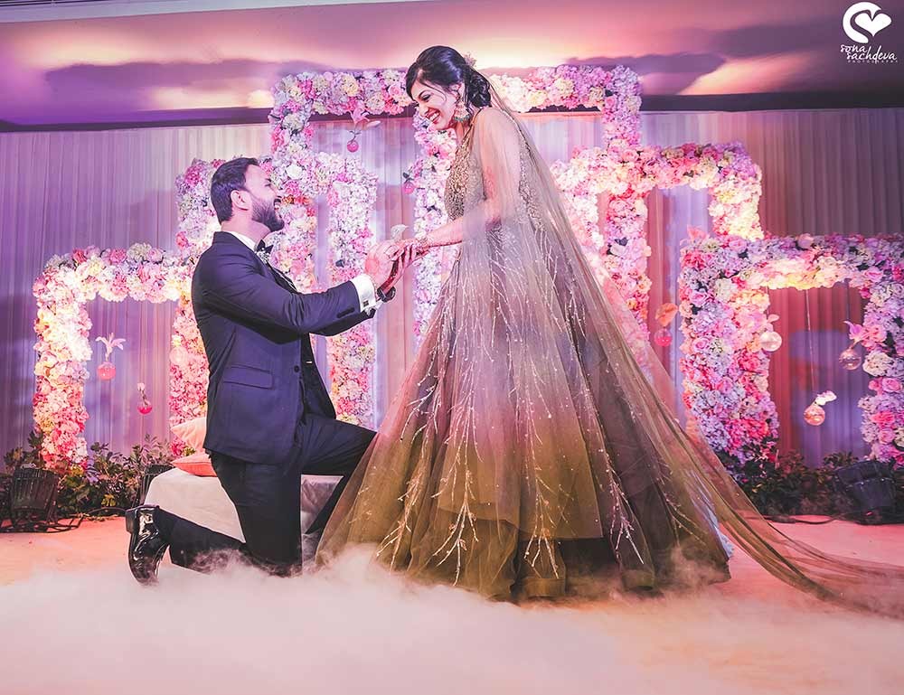 Deepanshu and Sonali on a beautifully lit stage during their wedding reception