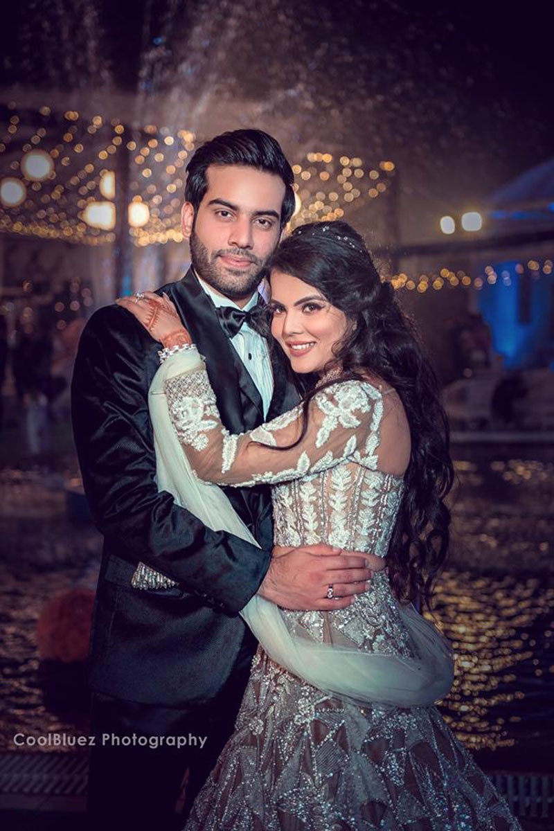 Neha and Pawan at their wedding reception amid sparkling lights