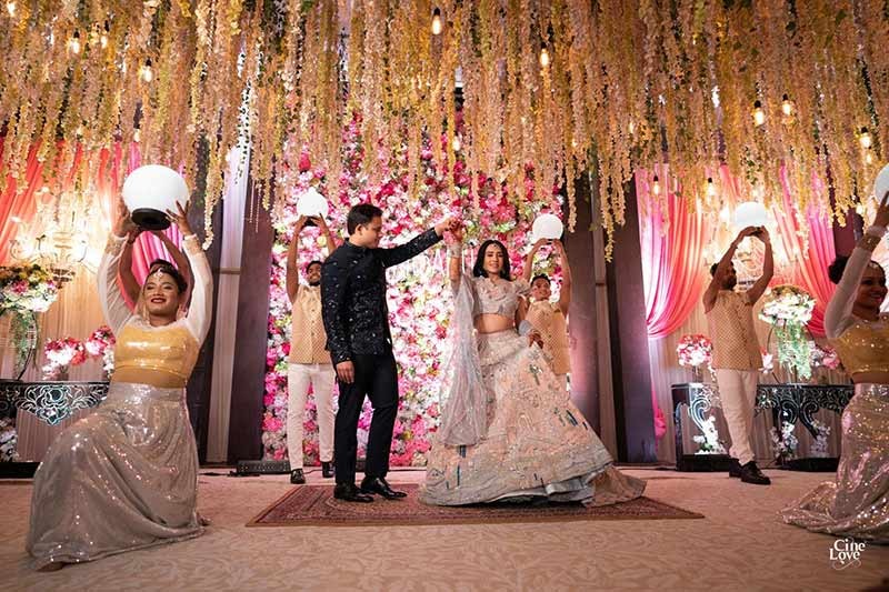Bride and groom standing together at the decorated aisle