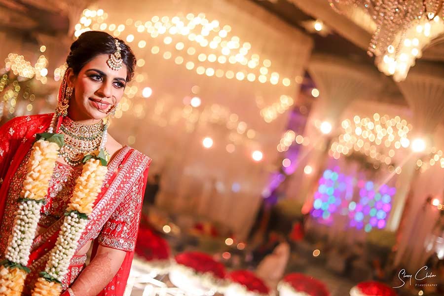 Close-up portrait of bride in red attire with traditional jewellery