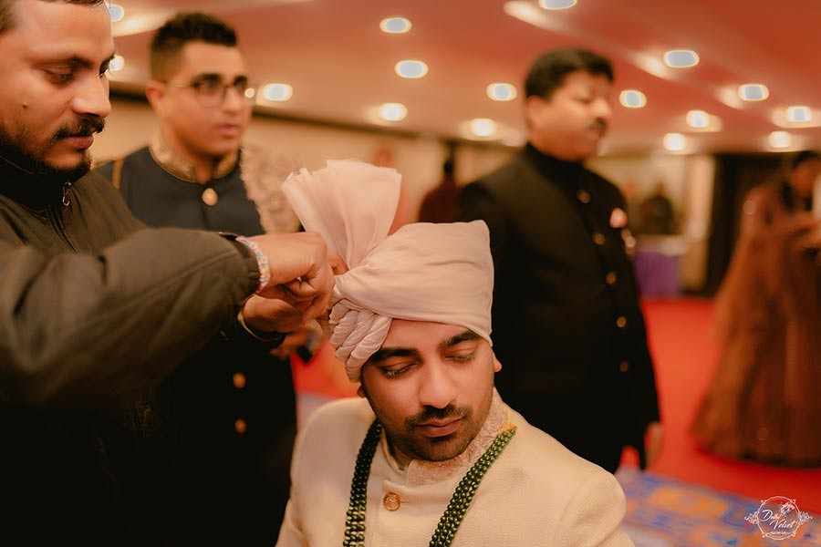 Prakriti and Sahil with a guest during a moment at their wedding celebration