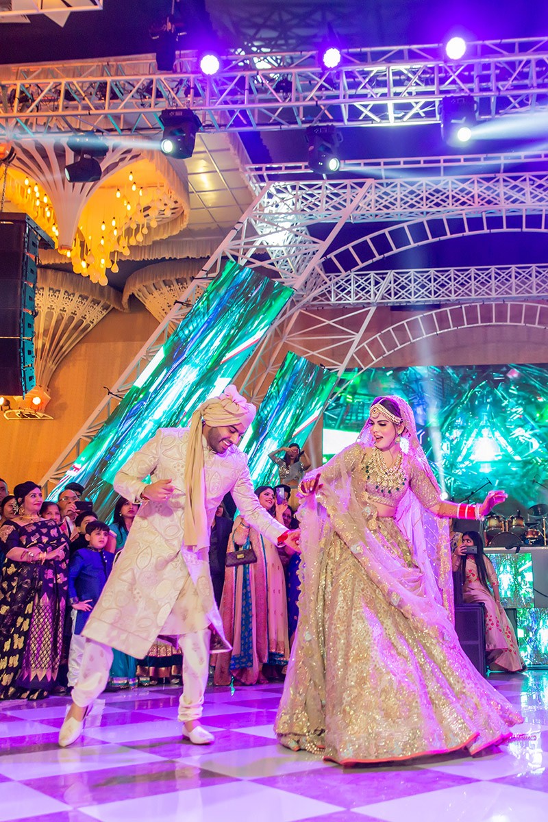Neha and Pawan amid festive lighting at their wedding
