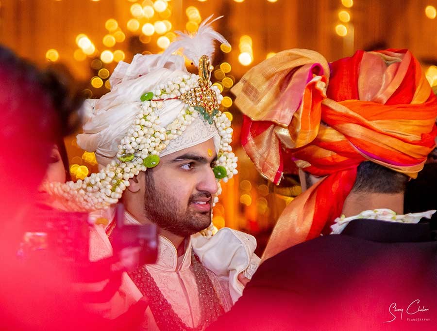 Close-up portrait of groom in a floral sehra veil