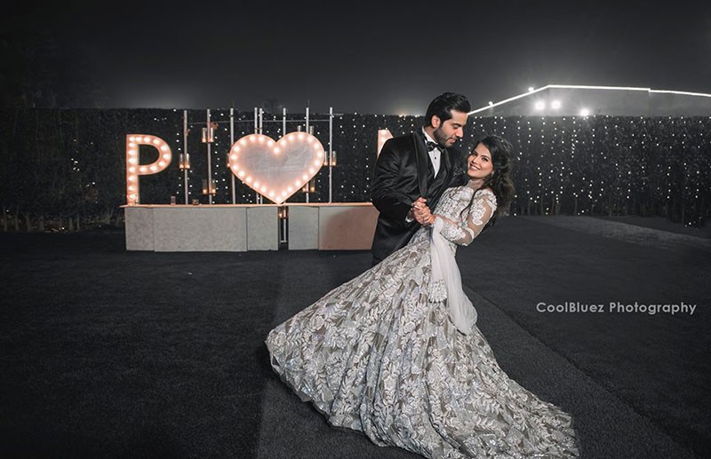 Bride Neha in a white gown at her wedding reception
