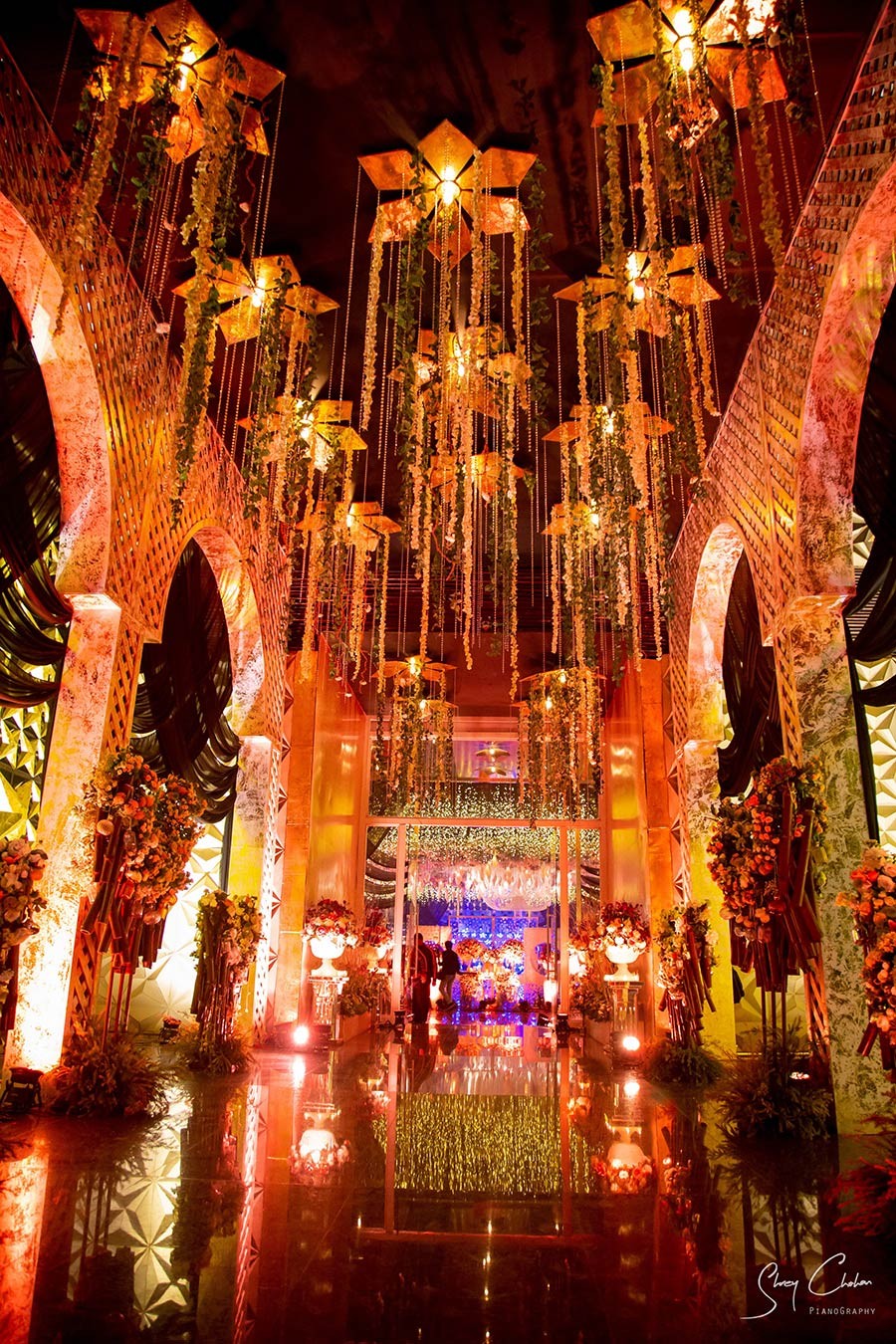 Bride and groom embracing warmly with decor lights in the background